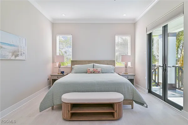 a bedroom with a bed a large window and walk in closet