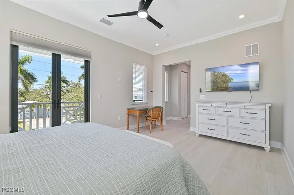 a bedroom with furniture and a flat screen tv
