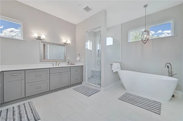 a spacious bathroom with double sink and a mirror