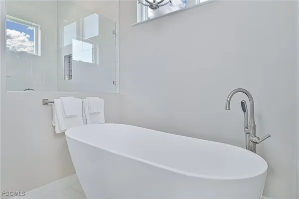 a room with furniture pool table wooden floor and windows