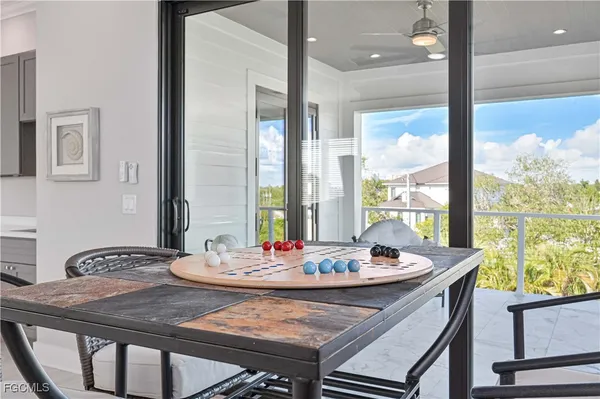 a living room with furniture and a floor to ceiling window