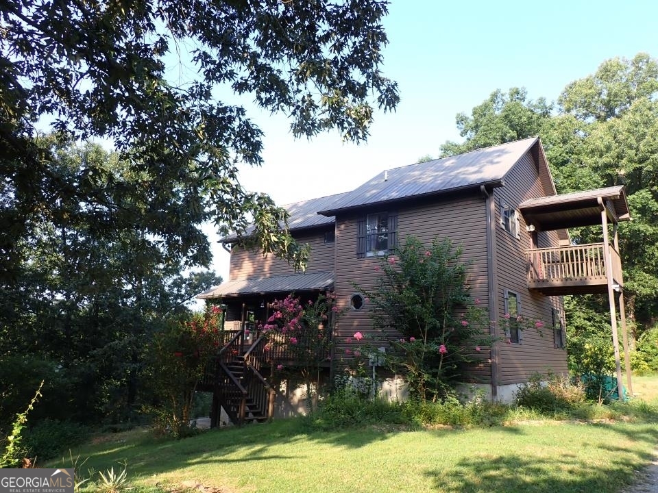 978 North Old Rome Dalton Road Northwest Calhoun, GA 30701 - Photo 1 of 1 a front view of a house with a garden