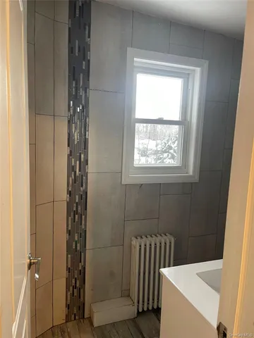 a bathroom with a bathtub and shower