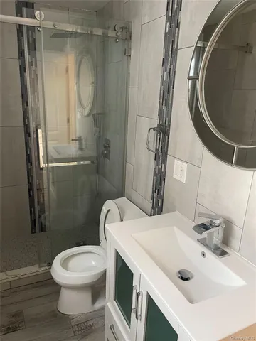 a bathroom with a sink toilet and shower