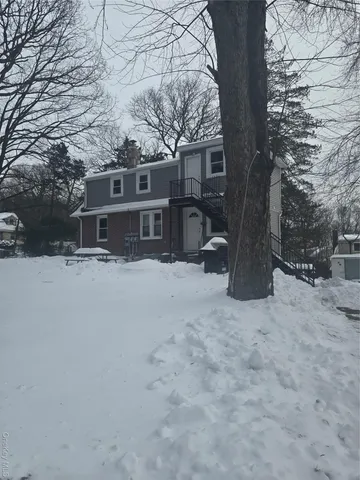 a view of a house with a snow in the yard