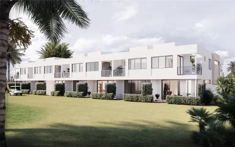 a view of a white building with a swimming pool