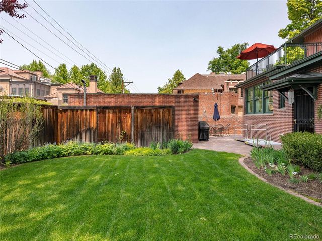 a front view of a house with yard and green space