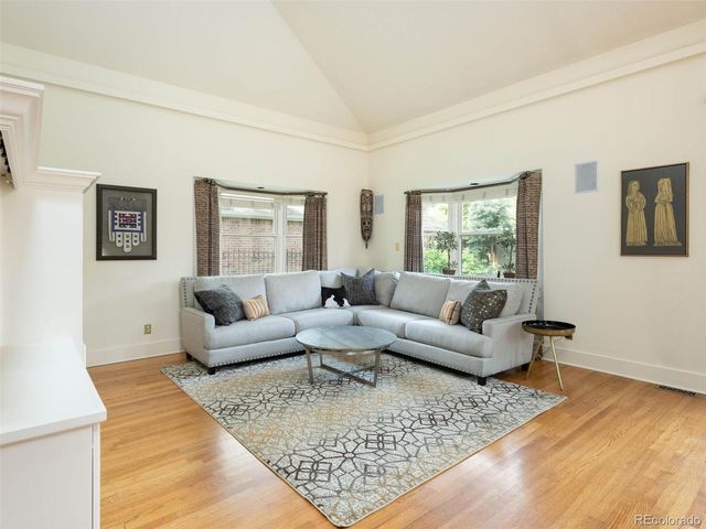 a living room with couches and a couch with wooden floor