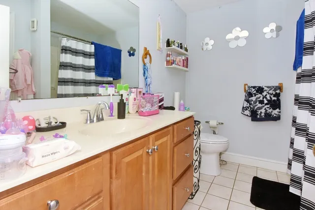 a bathroom with a sink vanity mirror and toilet