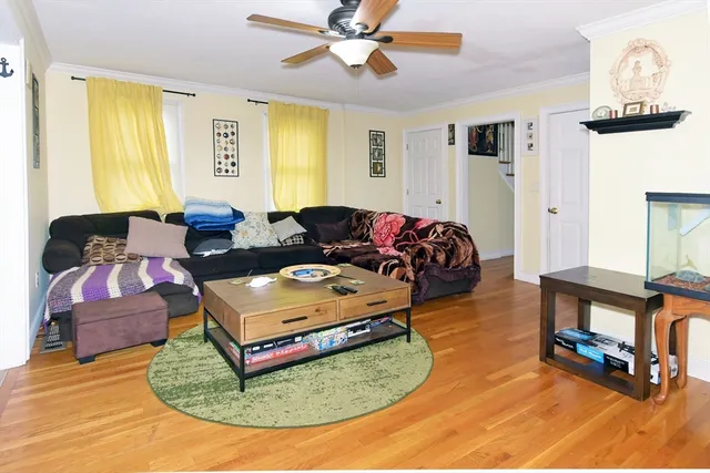 a living room with furniture rug and a window