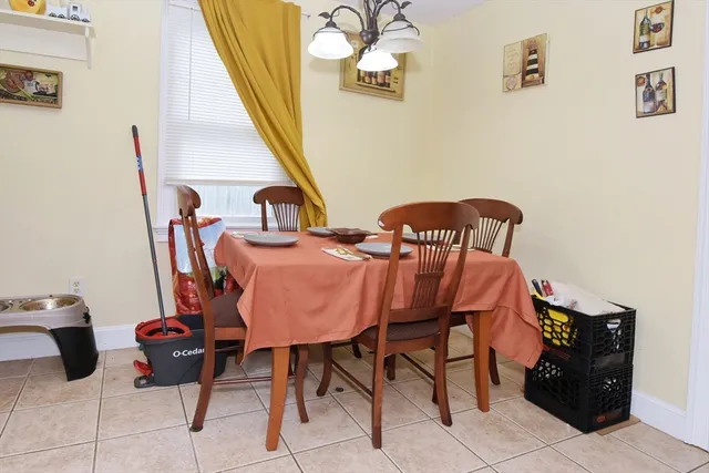 a view of a dining room with furniture and a chandelier