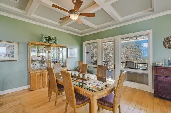 a kitchen with stainless steel appliances granite countertop a stove a sink dishwasher and cabinets with wooden floor