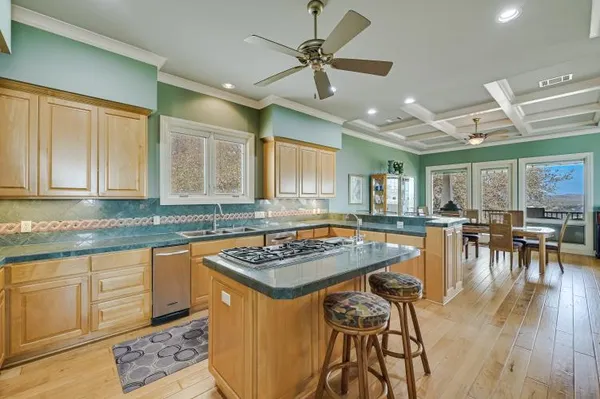 a kitchen with stainless steel appliances granite countertop a sink and cabinets