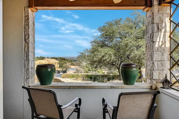 a view of a livingroom with furniture and floor to ceiling window