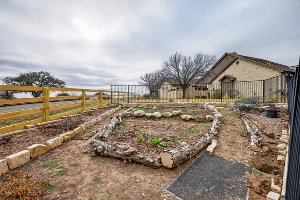 a view of house with yard and trees in the background