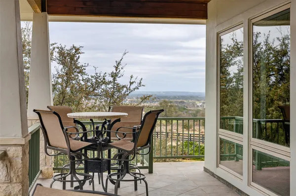 a view of a room with a table and chairs