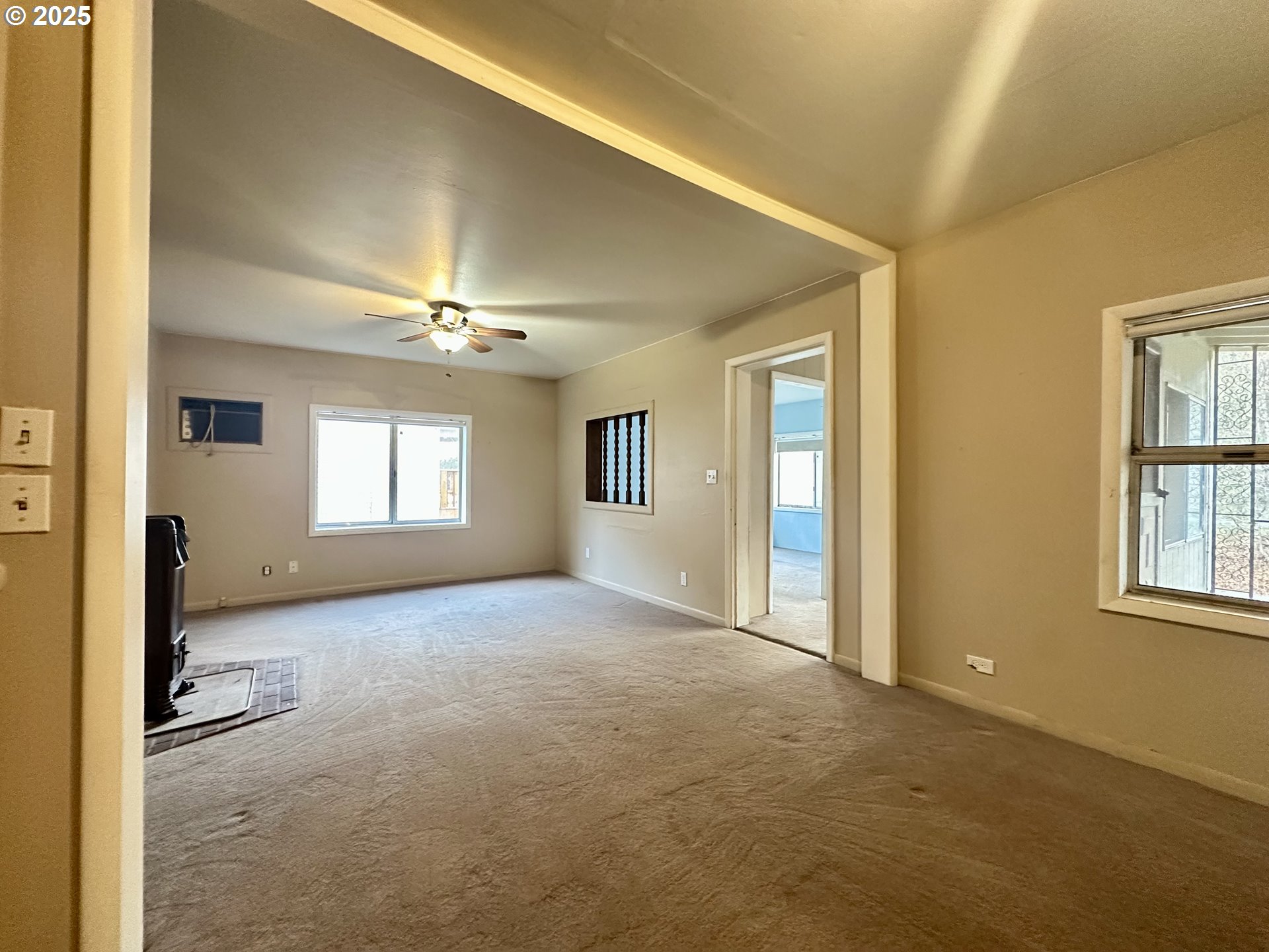 517 Main Street Klickitat, WA 98628 - Photo 22 of 41 an empty room with windows and chandelier fan