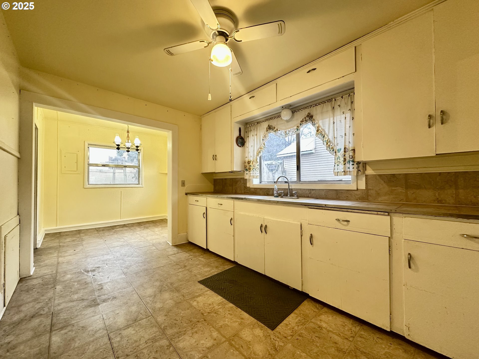 517 Main Street Klickitat, WA 98628 - Photo 32 of 41 a large white kitchen with a large window appliances and cabinets