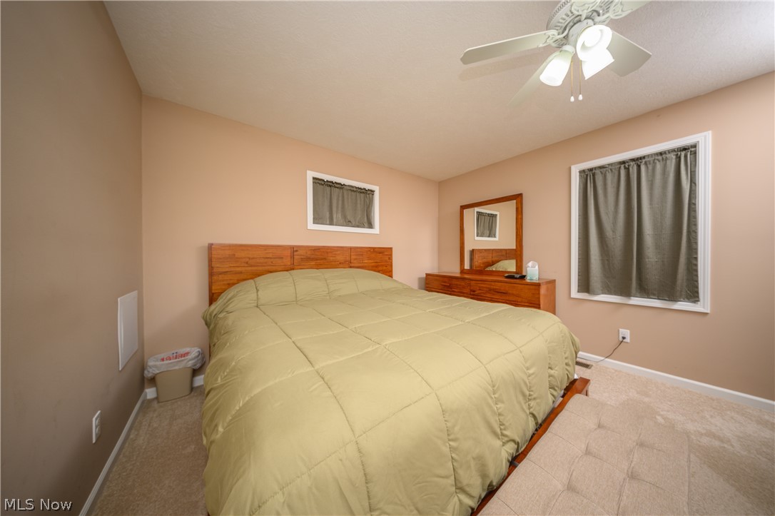4431 7th Street Northwest Canton, OH 44708 - Photo 11 of 23 Carpeted bedroom featuring a ceiling fan and baseboards