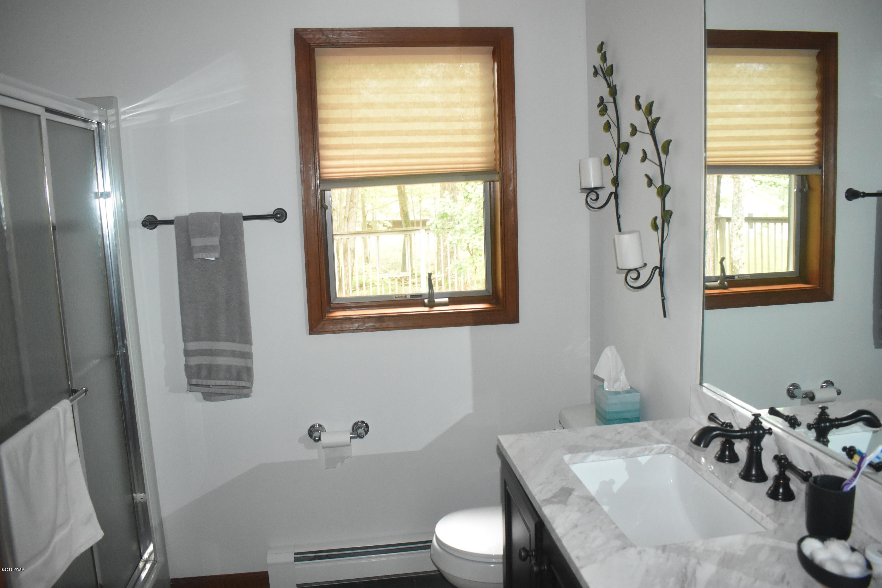 105 Rodeo Drive Hawley, PA 18428 - Photo 14 of 42 a bathroom with a sink a toilet and shower