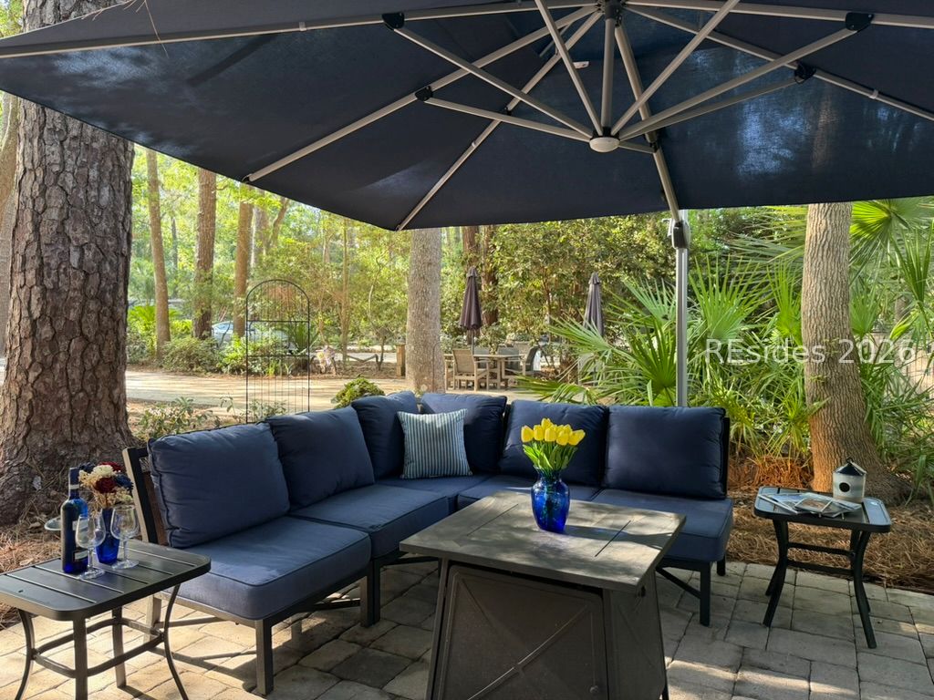 133 Arrow Road, Unit 23 Hilton Head Island, SC 29928 - Photo 3 of 22 L-shaped sofa surrounds fire table and end tables