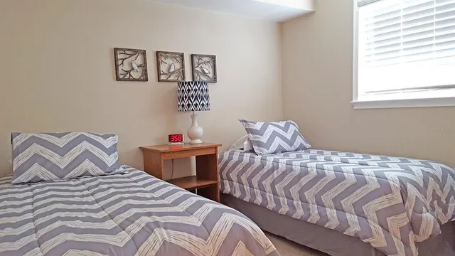 a bedroom with two beds and a window