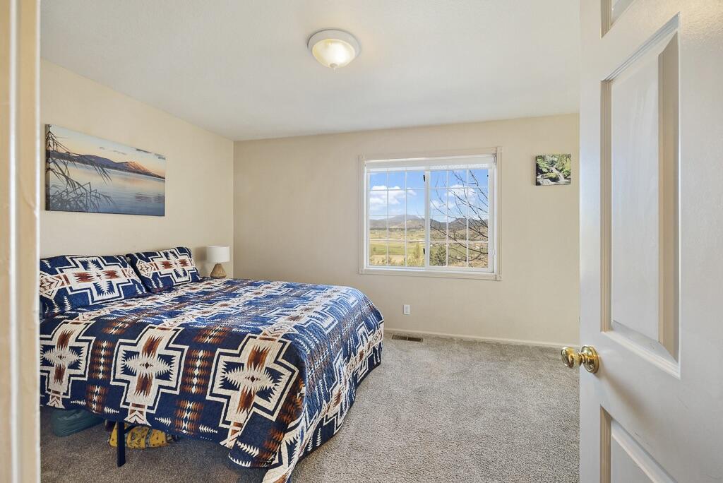 13351 Crystal Springs Road Klamath Falls, OR 97603 - Photo 37 of 51 a bedroom with a bed table and a window