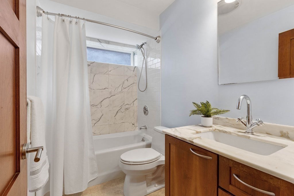 27 West Street, Unit 1 Cambridge, MA 02139 - Photo 11 of 26 a bathroom with a sink a toilet and shower