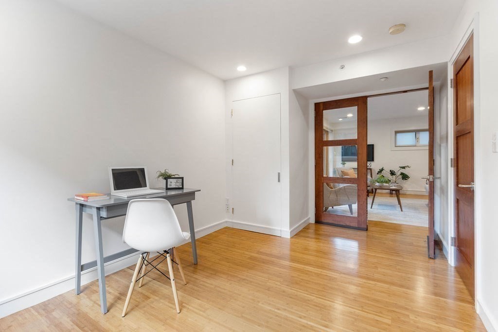 27 West Street, Unit 1 Cambridge, MA 02139 - Photo 12 of 26 a workspace with furniture and wooden floor