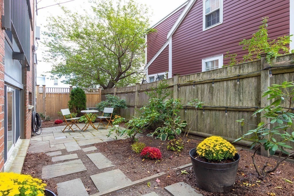 27 West Street, Unit 1 Cambridge, MA 02139 - Photo 14 of 26 a view of a chairs and table in backyard
