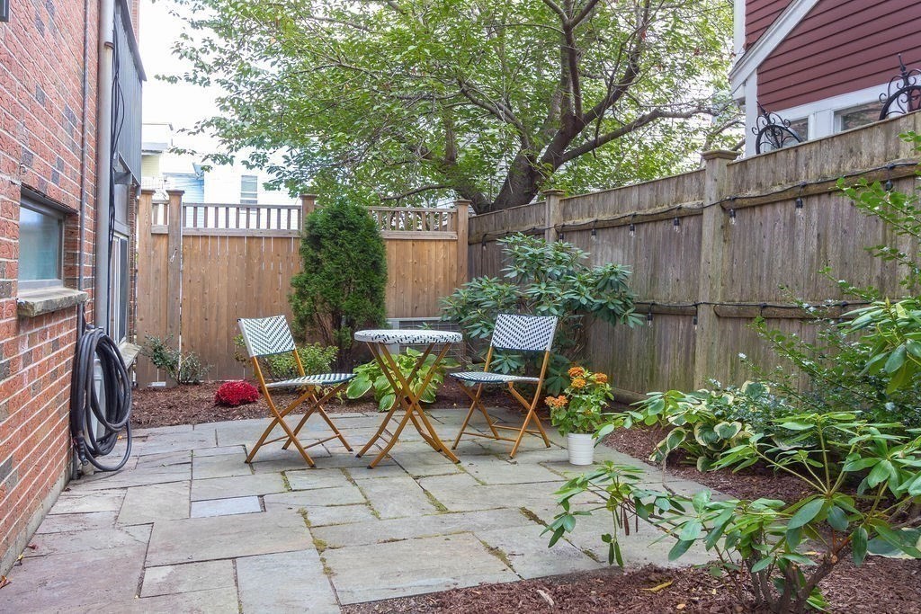 27 West Street, Unit 1 Cambridge, MA 02139 - Photo 16 of 26 a view of backyard with outdoor seating and plants