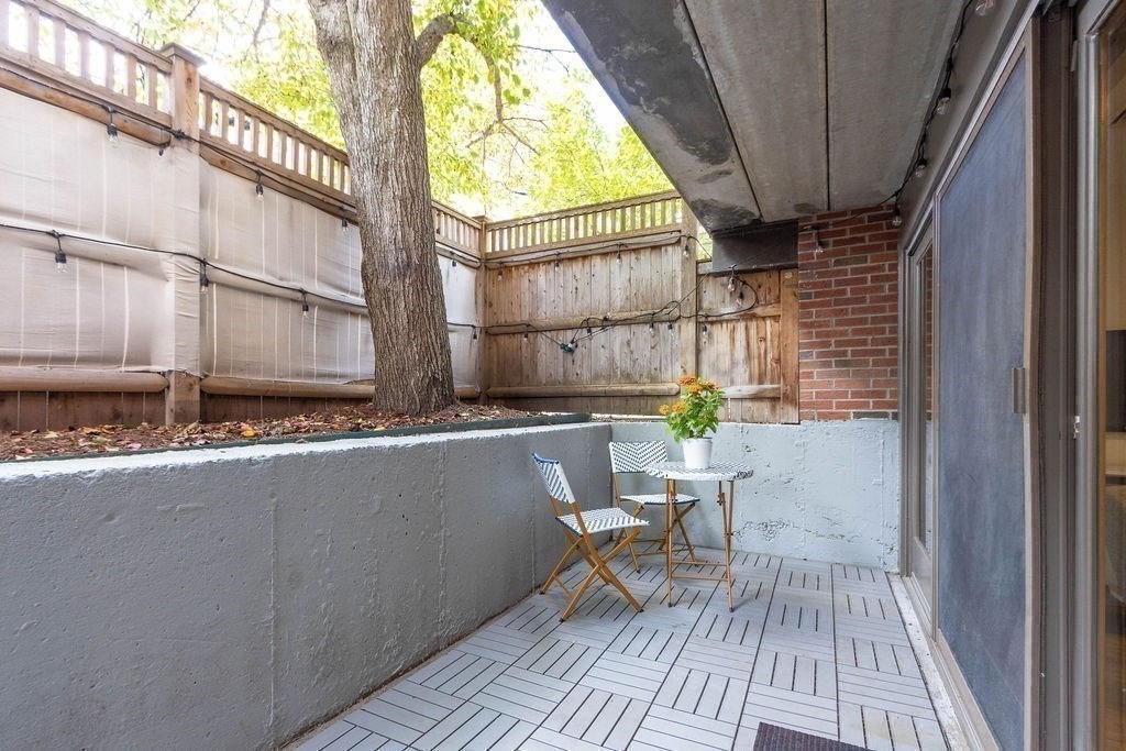27 West Street, Unit 1 Cambridge, MA 02139 - Photo 18 of 26 a balcony with table and chairs