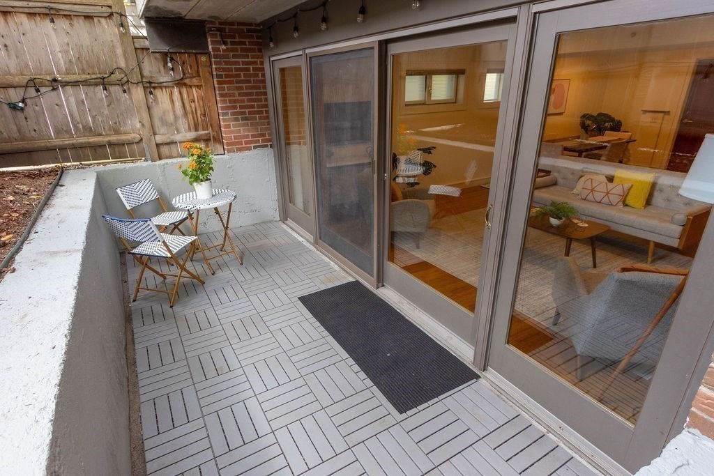 27 West Street, Unit 1 Cambridge, MA 02139 - Photo 19 of 26 a balcony with table and chairs