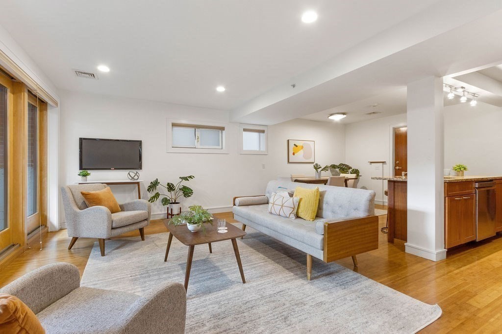 27 West Street, Unit 1 Cambridge, MA 02139 - Photo 2 of 26 a living room with furniture kitchen view and a large window