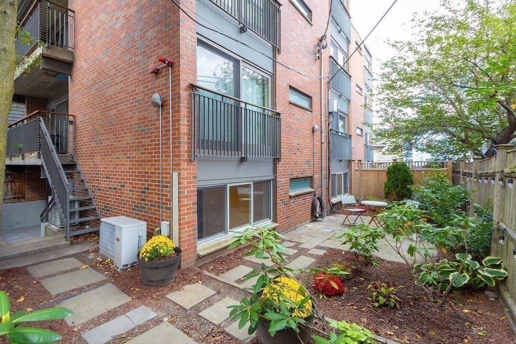27 West Street, Unit 1 Cambridge, MA 02139 - Photo 21 of 26 a front view of a house with a garden