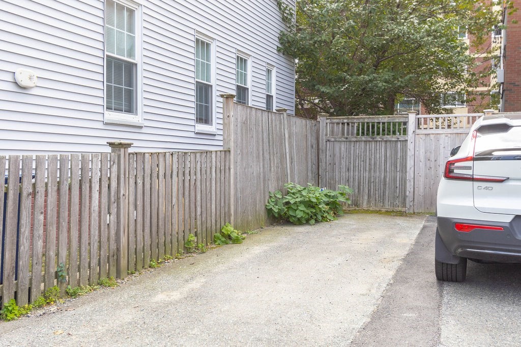 27 West Street, Unit 1 Cambridge, MA 02139 - Photo 25 of 26 a view of a backyard with a small cabin and a chair