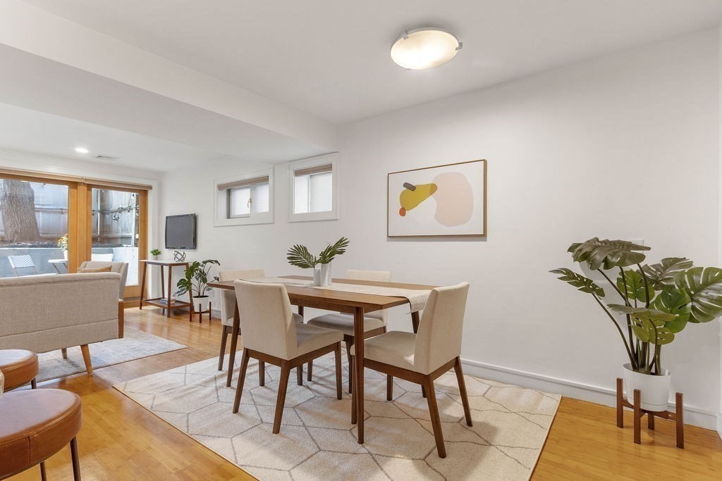 27 West Street, Unit 1 Cambridge, MA 02139 - Photo 3 of 26 a view of a dining room with furniture and a potted plant