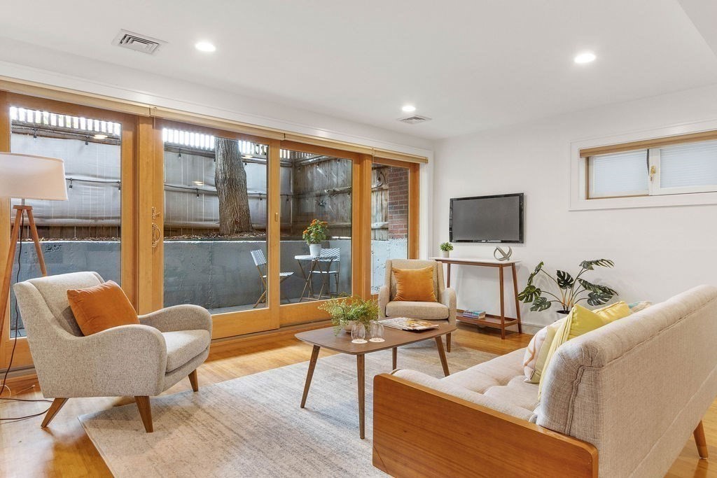 27 West Street, Unit 1 Cambridge, MA 02139 - Photo 4 of 26 a living room with furniture and a flat screen tv