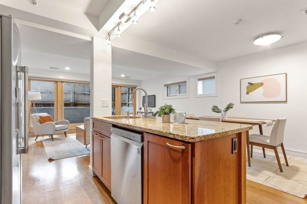 27 West Street, Unit 1 Cambridge, MA 02139 - Photo 7 of 26 a kitchen with stainless steel appliances granite countertop a sink and cabinets