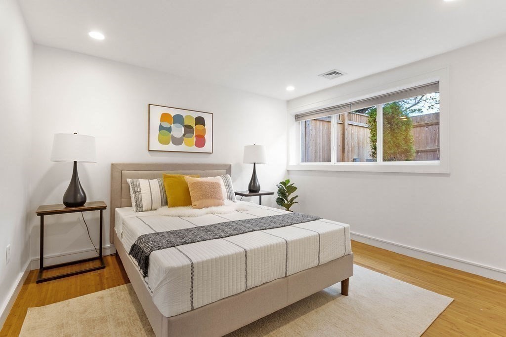 27 West Street, Unit 1 Cambridge, MA 02139 - Photo 9 of 26 a bedroom with a bed and wooden floor