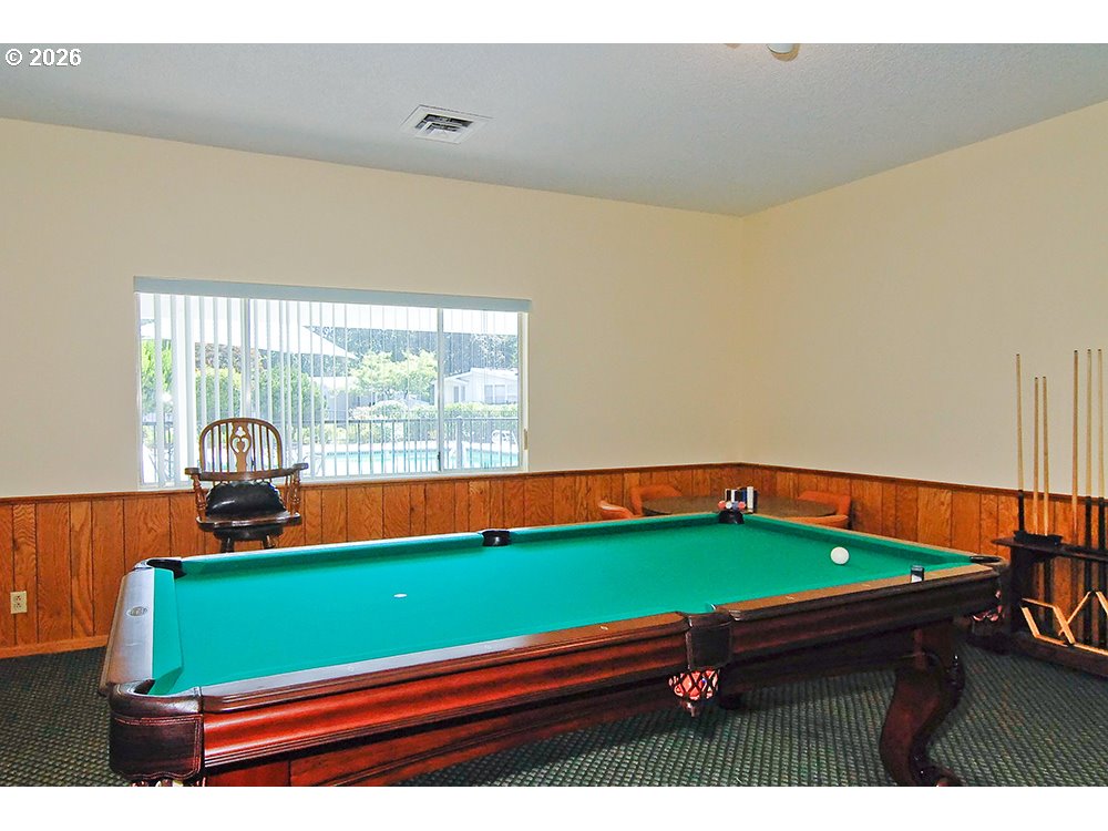 1475 Green Acres Road, Unit 83 Eugene, OR 97408 - Photo 32 of 37 a room with pool table and a floor to ceiling window