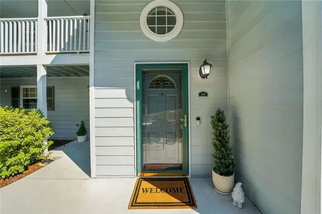 a front view of a house with a garden