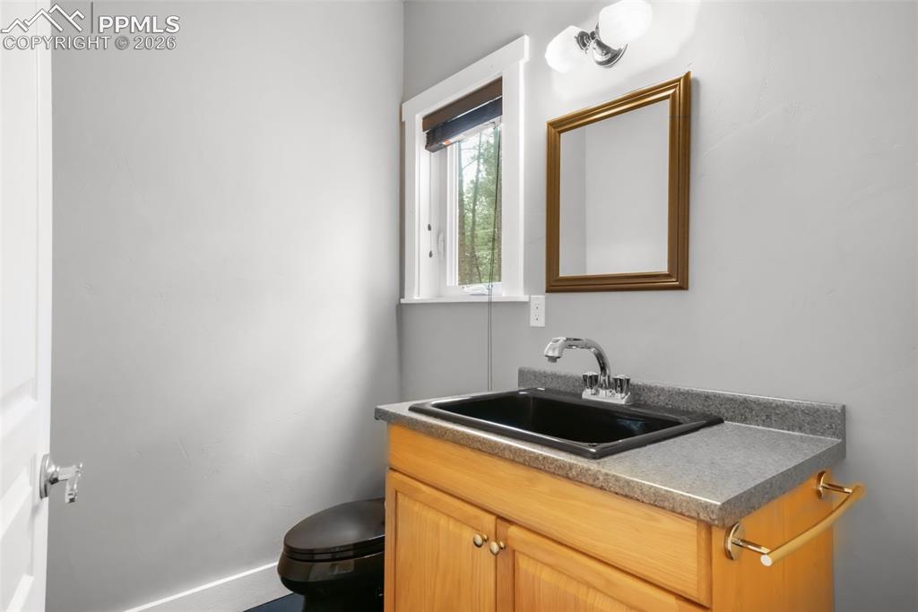 19010 Deerfield Road Monument, CO 80132 - Photo 44 of 50 a kitchen with a sink cabinets and a window
