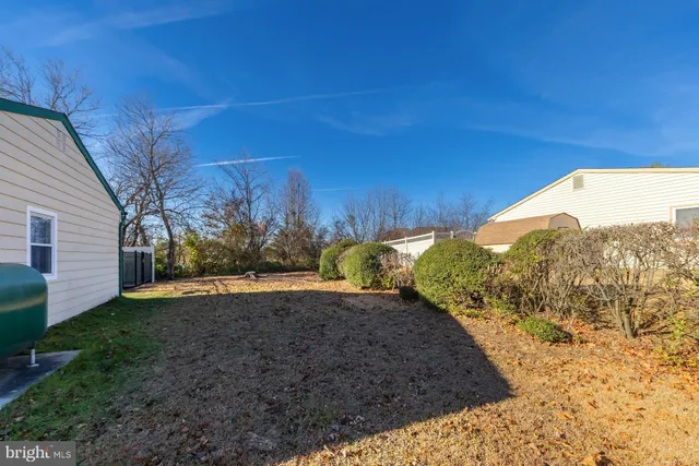 a view of a yard with a house in the background