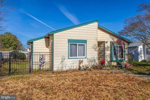 a view of a house with a small yard and potted plants