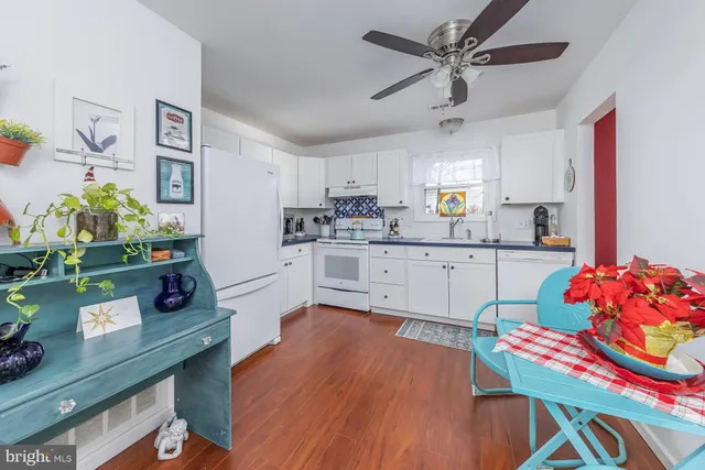 a kitchen with stainless steel appliances kitchen island granite countertop a cabinets and wooden floor