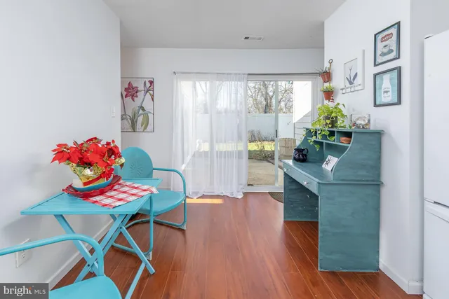 a view of a dining room with furniture and a potted plant