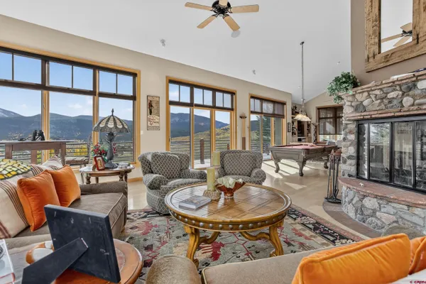a living room with furniture and a floor to ceiling window