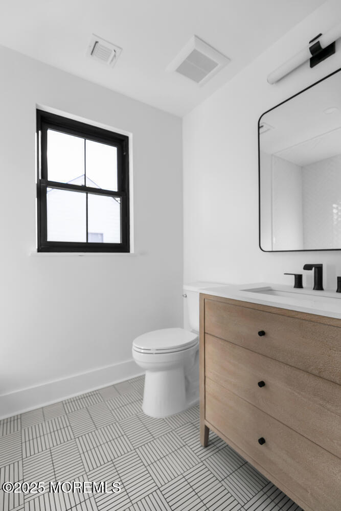 516 River Road Fair Haven, NJ 07704 - Photo 40 of 62 a bathroom with a sink a toilet and mirror