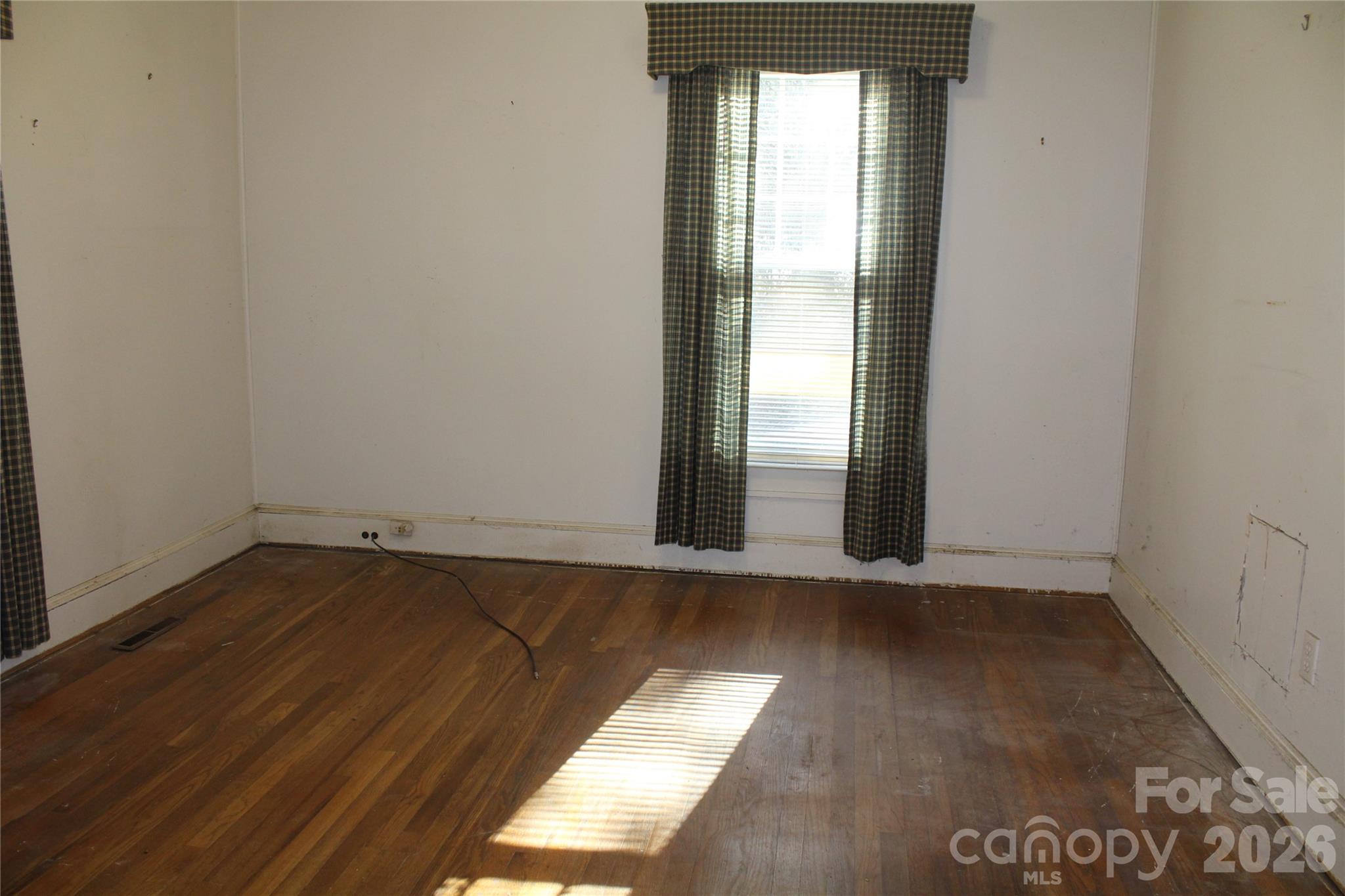 113 Williams Street Morganton, NC 28655 - Photo 13 of 20 an empty room with wooden floor and windows